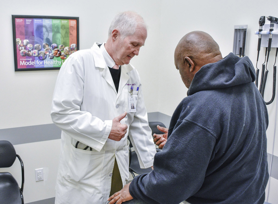 <strong>Dr. Scott Morris talks with a patient at Church Health.</strong> (Courtesy Church Health)