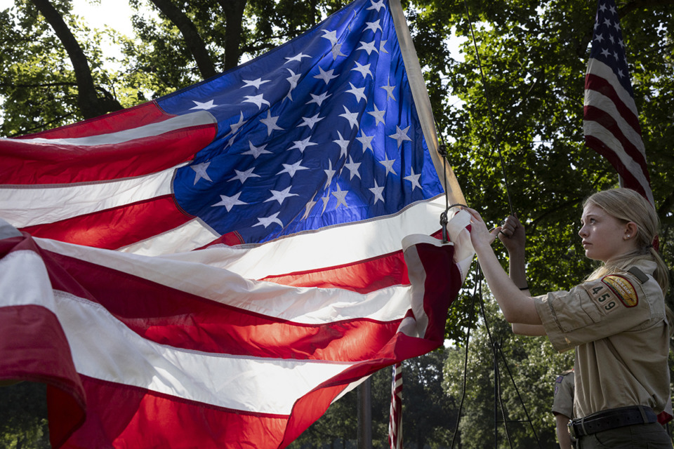 <strong>Felicity Whartenby raises the flag Saturday, May 25 during the Boy Scouts of America annual Memorial Day Flag Placement at Memphis National Cemetery at 3568 Townes Ave.&nbsp;in the Nutbush neighborhood.</strong> (Ziggy Mack/Special to The Daily Memphian)