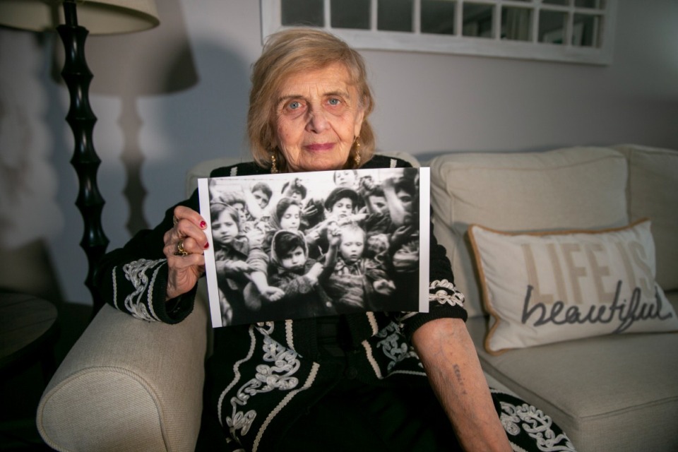 <strong>In Morristown, New Jersey, on March 13, 2023, Holocaust survivor Tova Friedman, 85, holds out her left arm to show the number the Nazis tattooed. In her right hand, she holds a photo of her as a 6-year-old (on the left in the picture), holding out the same arm to show the tattoo to the camera in 1945 after the Soviet military liberated Auschwitz concentration camp. To combat anti-semitism, Friedman's grandson Aron Goodman records TikTok videos of her describing the Holocaust that have millions of views on the social media platform.</strong> (Ted Shaffrey/AP file)