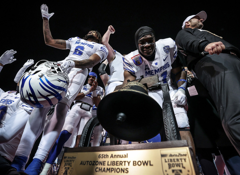 <strong>Memphis players and coaches celebrate with the Liberty Bowl trophy after winning the AutoZone Liberty Bowl over Iowa State in Memphis, Tennessee Dec. 29, 2023.</strong> (Patrick Lantrip/The Daily Memphian file)