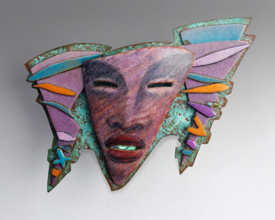 <strong>&ldquo;Mask Brooch&rdquo; by Martha Banyas<em>&nbsp;</em>is made of copper and&nbsp;abalone and is one of 160 pieces of enamel art given to the Metal Museum this year by the Enamel Arts Foundation.</strong> (Submitted)