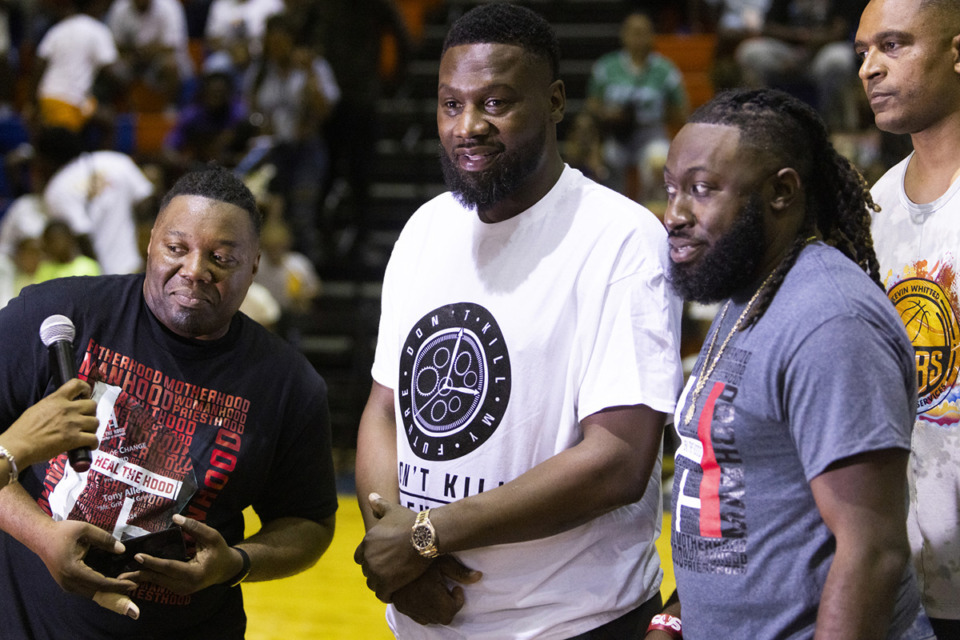 <strong>Heal the Hood founder LaDell Beamon (left) presents the Heroes of Change Award to former Memphis Grizzlies forward Tony Allen during the Heal the Hood Foundation Celebrity Basketball Game at Ridgeway High School Saturday, June 8.</strong> (Brad Vest/Special to The Daily Memphian)