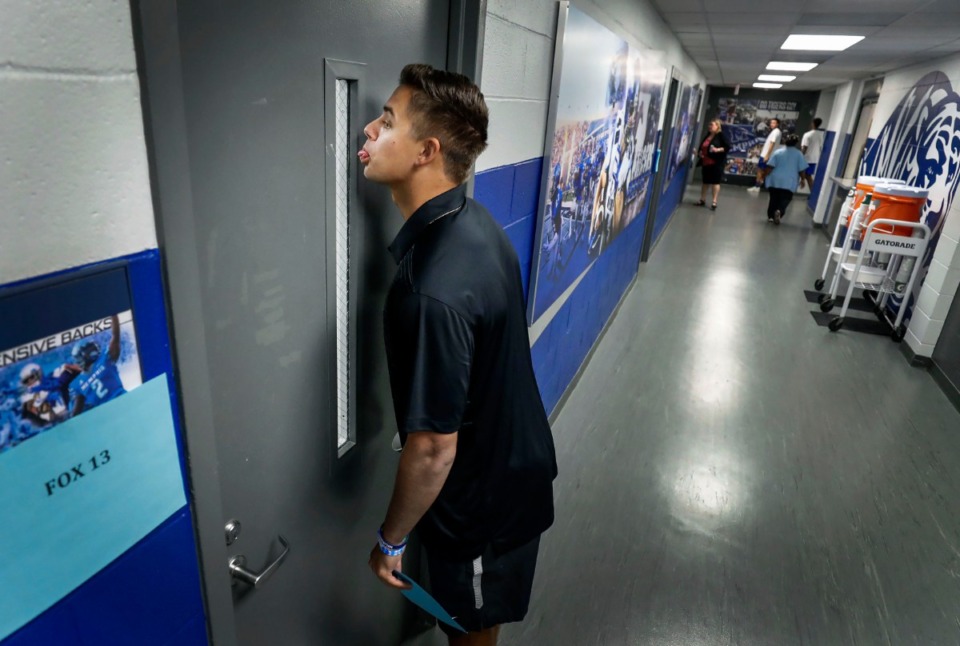 <strong>University of Memphis starting quarterback Brady White sticks out his tongue while joking with his teammates through a door at the Billy J. Murphy Football Complex on Media Day, Thursday, Aug. 1, 2019. The graduate transfer is more confident and comfortable in his role as he begins his second season at Memphis.</strong> (Mark Weber/Daily Memphian)