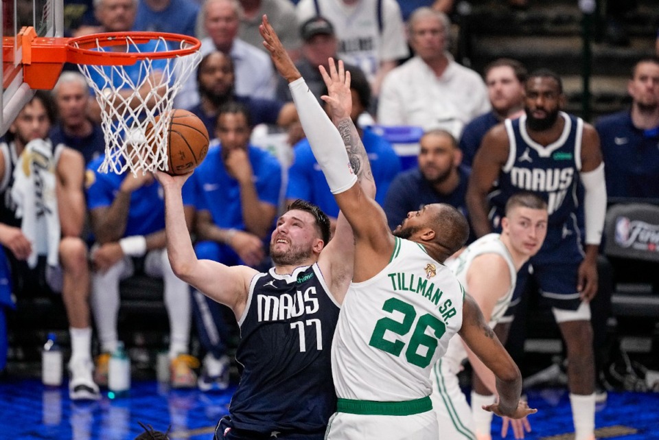 <strong>Dallas Mavericks guard Luka Doncic, left, goes up for a basket against Boston Celtics forward Xavier Tillman during the first half in Game 3 of the NBA basketball finals, Wednesday, June 12, 2024, in Dallas.</strong> (Tony Gutierrez/AP Photo)