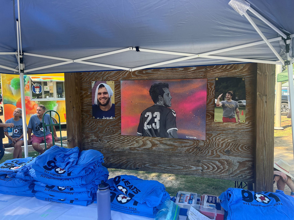 <strong>The check-in tent at the Cleats901 tournament featured photos and artwork of Chester Linebarier.</strong> (Drew Hill/The Daily Memphian)