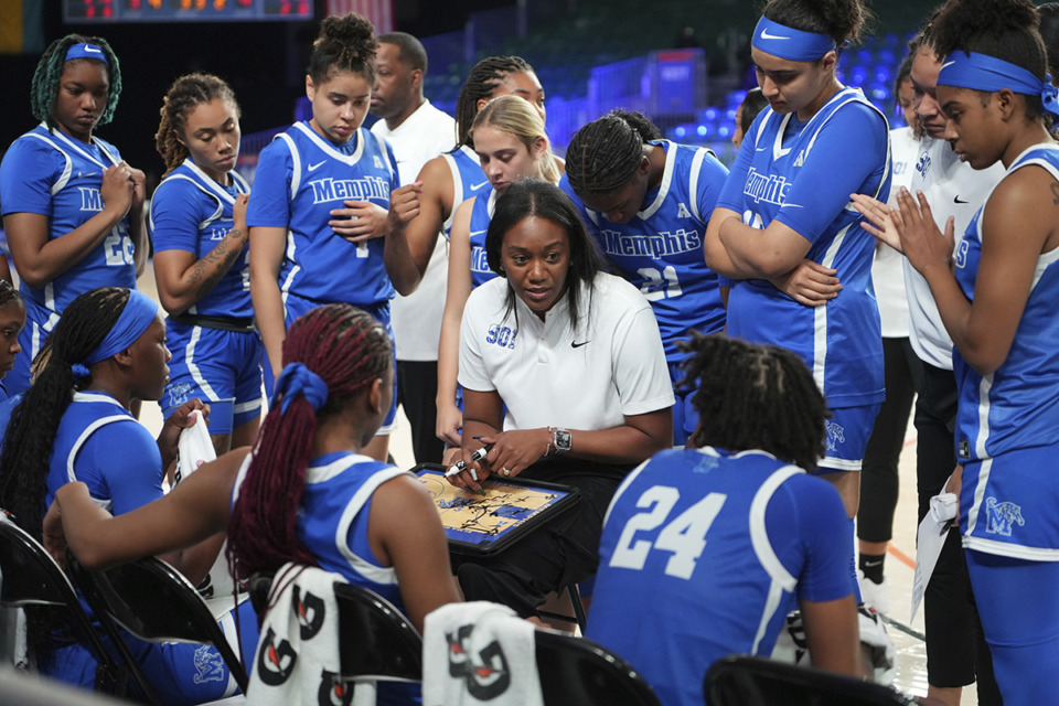 <strong>Alex Simmons (middle, in white) is beginning her second season as the head coach of the Memphis Tigers women&rsquo;s basketball team.</strong> (Ronnie Archer/Bahamas Visual Services via AP)