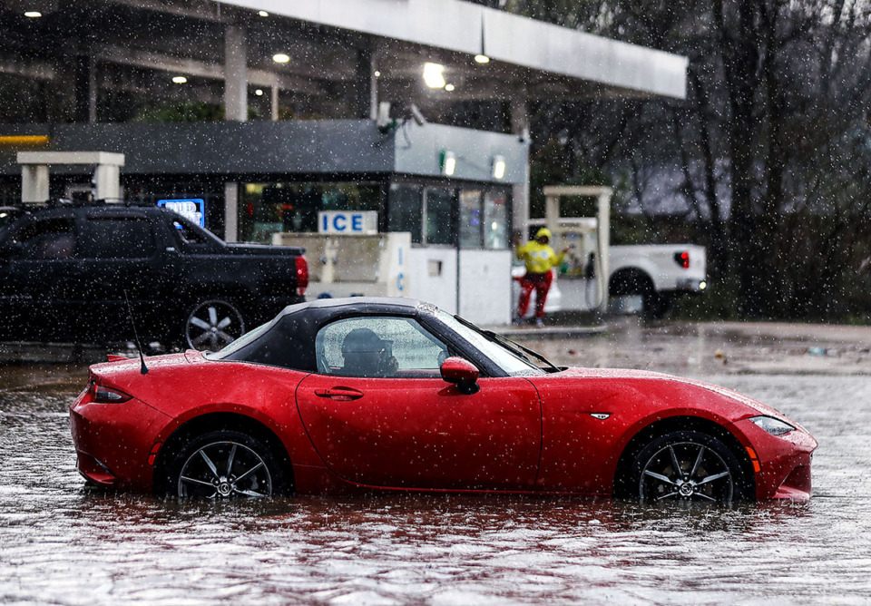 <strong>A man makes a phone call after getting stuck in a flooded portion of Jackson Avenue March 17, 2021.</strong> (Patrick Lantrip/The Daily Memphian file)