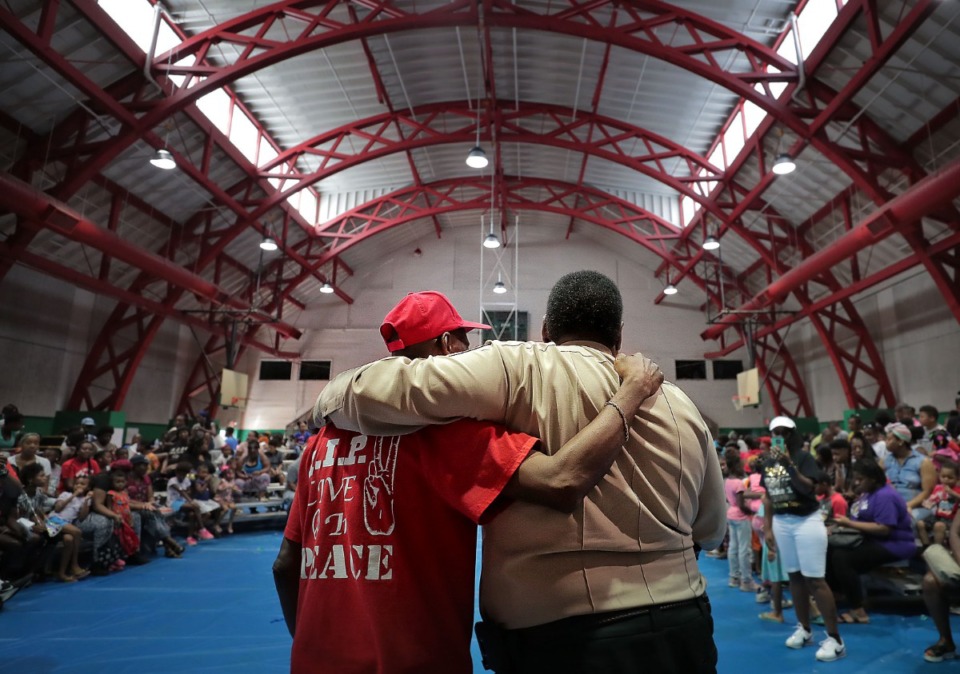 <strong>F.F.U.N. president Stevie Moore (left) embraces Shelby County Sheriff Floyd Bonner Jr. during the "Stop the Killing" rally for students and parents at the Gaston Park Community Center on Aug. 3, 2019, hosted by F.F.U.N. to kick off the school year on a positive note and distribute much-needed school supplies.&nbsp;</strong>(Jim Weber/Daily Memphian)