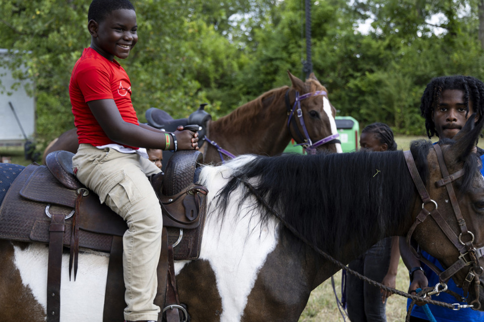 <strong>Dezman Dorsey, 8, left, enjoys his time on a horse while at the Tone Juneteenth Festival at the Orange Mound Tower June 16.</strong> (Brad Vest/Special to The Daily Memphian)