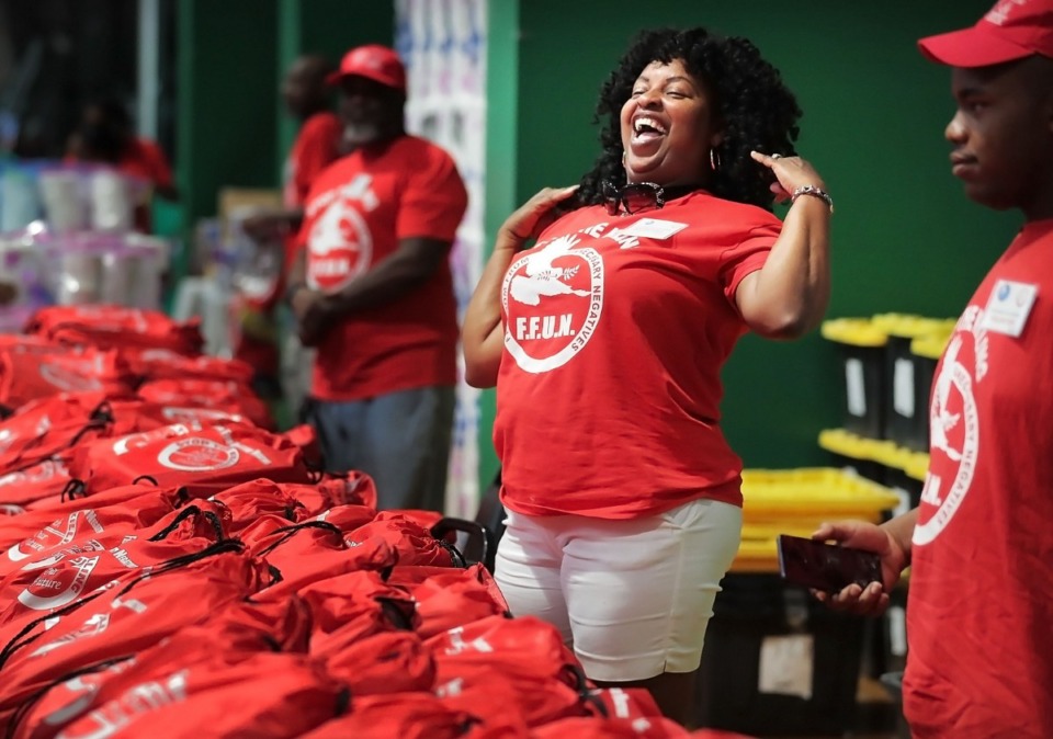 <strong>Lavator Thompson jokes with fellow volunteers while passing out free supplies during the "Stop the Killing" rally for students and parents at the Gaston Park Community Center on Aug. 3, 2019, hosted by F.F.U.N. to kick off the school year on a positive note and distribute much-needed school supplies.&nbsp;</strong>(Jim Weber/Daily Memphian)