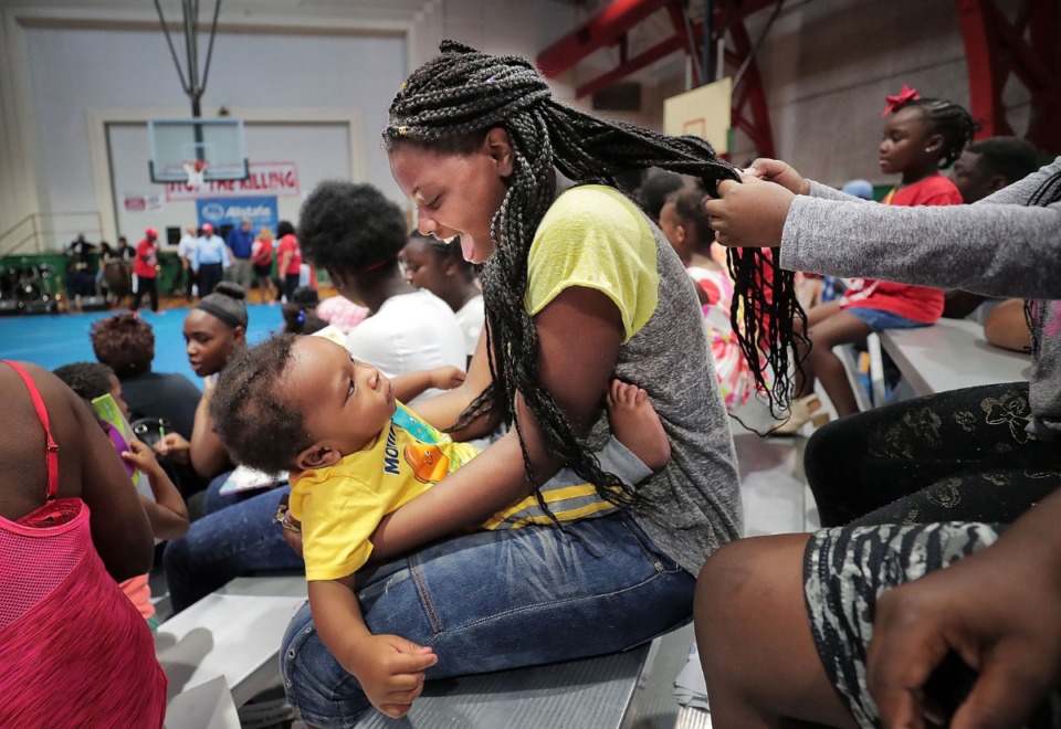 <strong>Jamaria Norman, 10, plays with one-year-old Jayvin Nathaniel during the "Stop the Killing" rally for students and parents at the Gaston Park Community Center on Aug. 3, 2019, hosted by F.F.U.N. to kick off the school year on a positive note and distribute much-needed school supplies.&nbsp;</strong>(Jim Weber/Daily Memphian)