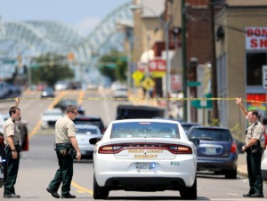 <strong>Several Sheriff's Office deputies let a field commander through the police tape that was blocking off Poplar in the wake of an officer-involved shooting in Downtown Memphis Monday, Aug. 5.</strong> (Patrick Lantrip/Daily Memphian)