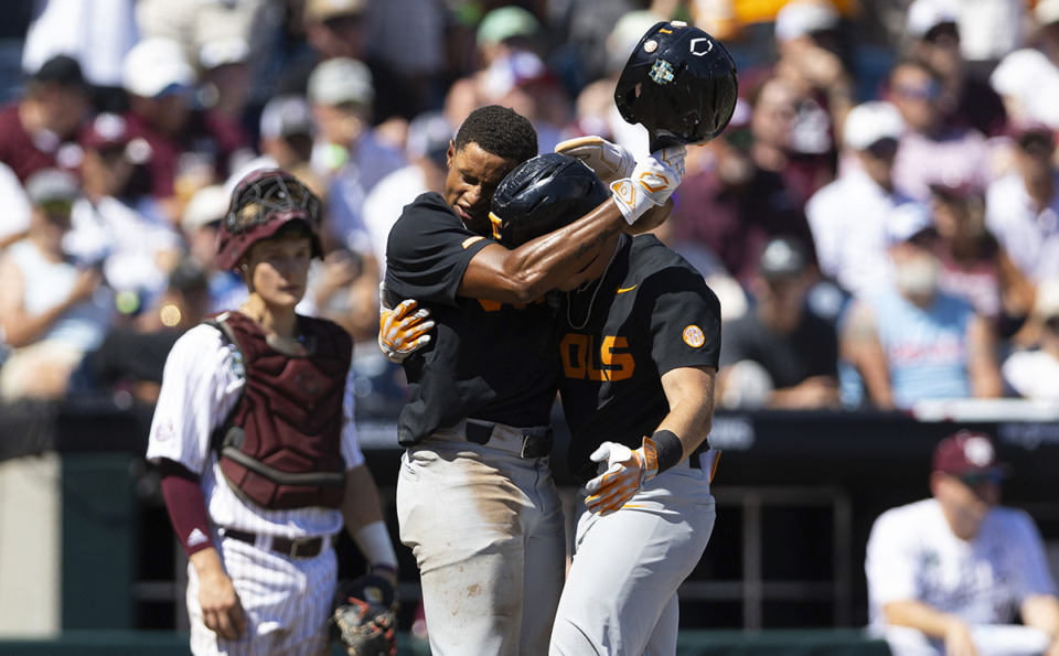 <strong>Tennessee's Christian Moore, left, hugs Dylan Dreiling at home plate after Dreiling hit a two-run home run against Texas A&amp;M in the seventh inning of Game 2 of the NCAA College World Series baseball finals in Omaha, Neb., Sunday, June 23, 2024.</strong> (Rebecca S. Gratz/AP)