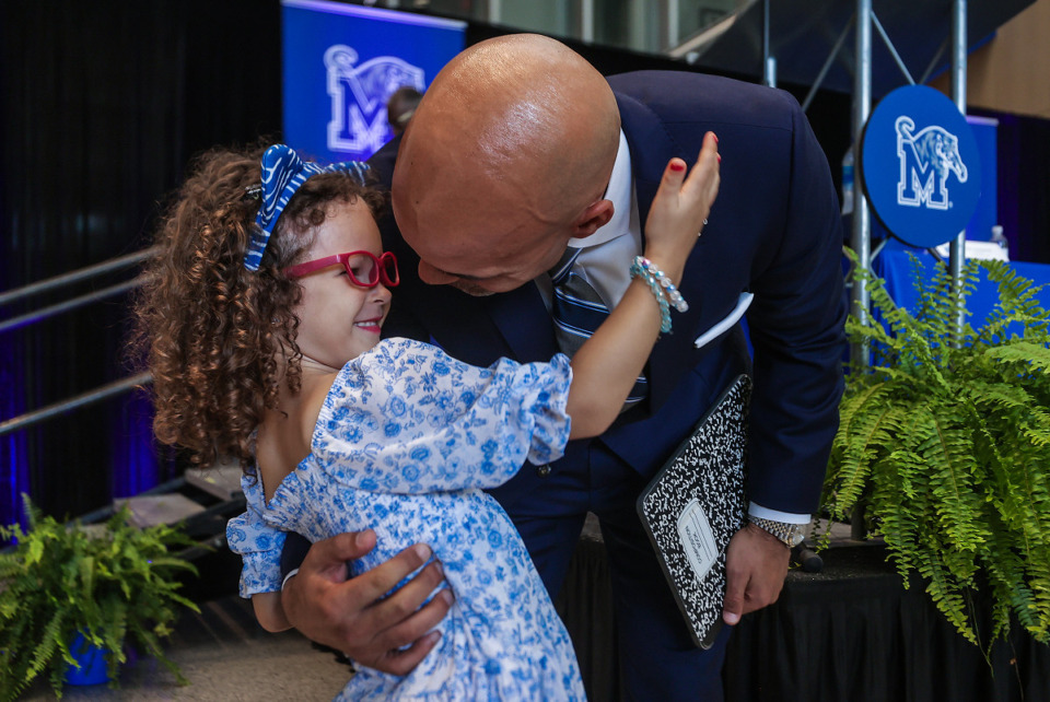 <strong>New University of Memphis athletic director Ed Scott hugs his daughter, 5-year-old Tia, at a June 28 press conference announcing his arrival.</strong> (Patrick Lantrip/The Daily Memphian)