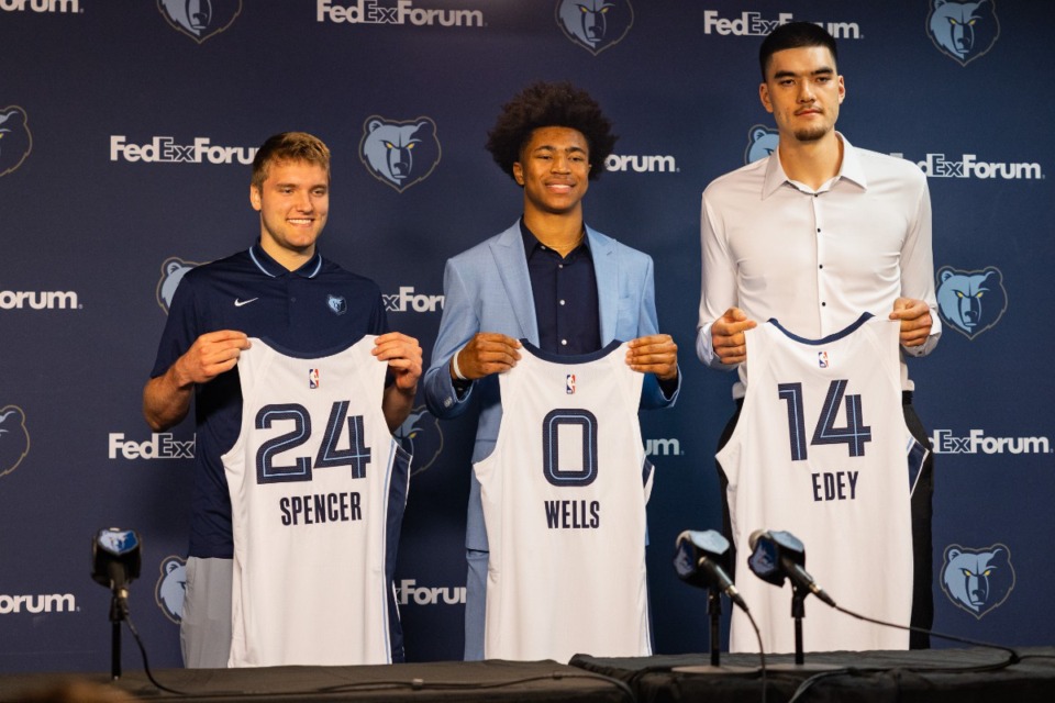 <strong>(From left) Cam Spencer, Jaylen Wells and Zach Edey show off their new jerseys at the Grizzlies press conference introducing their 2024 NBA Draft picks June 28.</strong> (Benjamin Naylor/The Daily Memphian)
