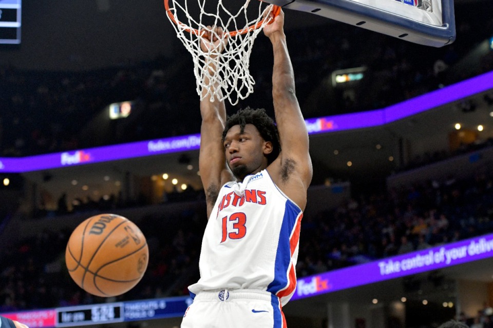 <strong>Detroit Pistons center James Wiseman hangs from the rim during the first half of the team's NBA basketball game against the Memphis Grizzlies on Friday, April 5, 2024, in Memphis.</strong> (Brandon Dill/AP File)