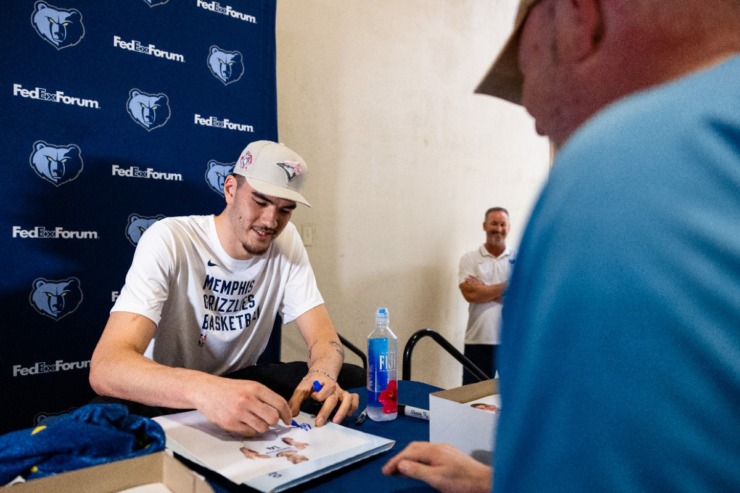 <strong>Zach Edey, the 9th pick of the 2024 NBA Draft by the Memphis Grizzlies, smiles as he signs autographs for fans at the Redbirds game July 3, 2024, at AutoZone Park.</strong> (Benjamin Naylor/The Daily Memphian)