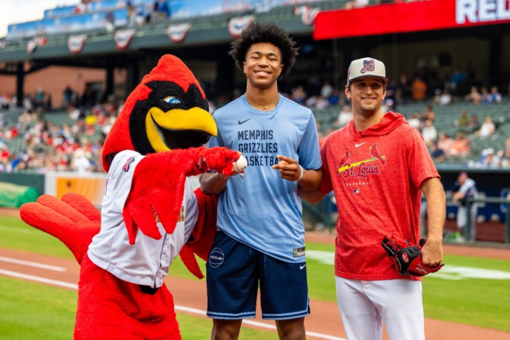 <strong>Jaylen Wells (middle) gets a personal welcome from&nbsp;Rockey&nbsp;the Rockin'&nbsp;Redbird (left) after throwing the first pitch July 3, 2024, at Autozone Park.</strong>&nbsp;(Benjamin Naylor/The Daily Memphian)