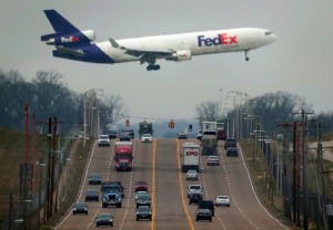 <strong>A FedEx plane passes low over Shelby Drive as it lands at Memphis International Airport. Mainly due to the presence of the FedEx hub, Memphis International is the world's second largest cargo airport.</strong> (Jim Weber/Daily Memphian)