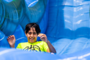 <strong>A child goes down a waterslide at the Overton Park Greensward July 6.</strong> (Benjamin Naylor/The Daily Memphian)