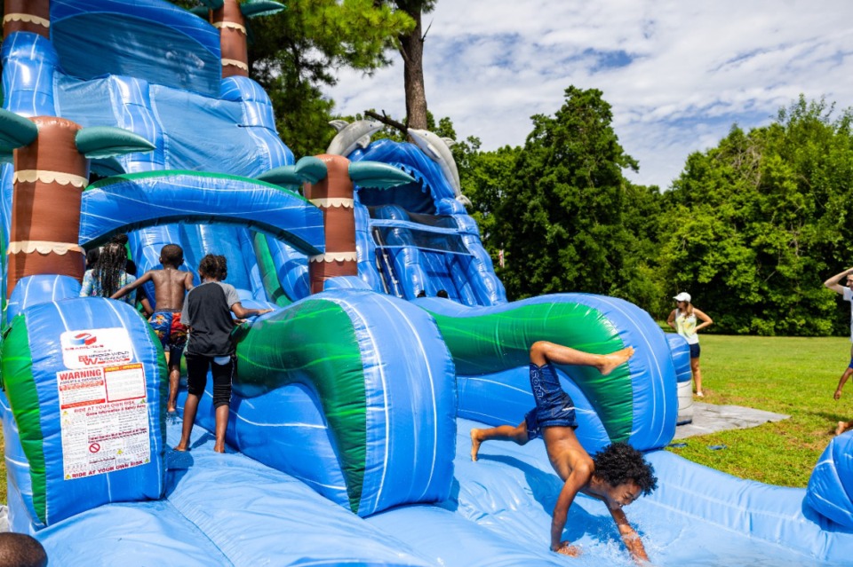 <strong>Kids enjoy water slides at Overton Park on the Greensward July 6.</strong> (Benjamin Naylor/The Daily Memphian)