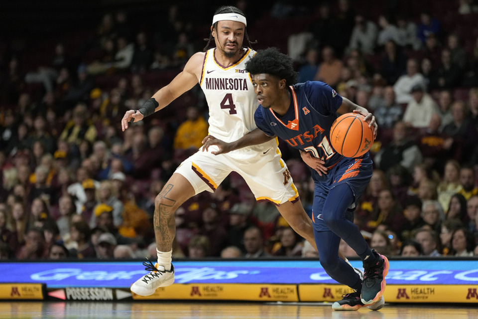 <strong>UTSA guard PJ Carter (21) dribbles down the court as Minnesota guard Braeden Carrington (4) defends during the first half of an NCAA college basketball game Friday, Nov. 10, 2023, in Minneapolis.</strong> (Abbie Parr/AP Photo file)