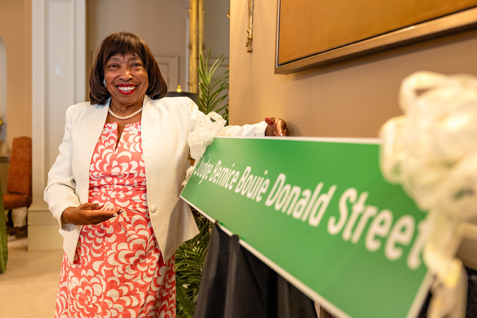 <strong>Retired judge Bernice Donald stands in front of a replica of the Downtown Memphis street sign that will be renamed in her honor.</strong> (Benjamin Naylor/The Daily Memphian)