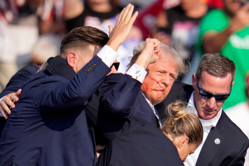 <strong>Republican presidential candidate former President Donald Trump is helped off the stage by U.S. Secret Service agents at a campaign event in Butler, Pa., on Saturday, July 13, 2024.</strong> (Gene J. Puskar/AP Photo)