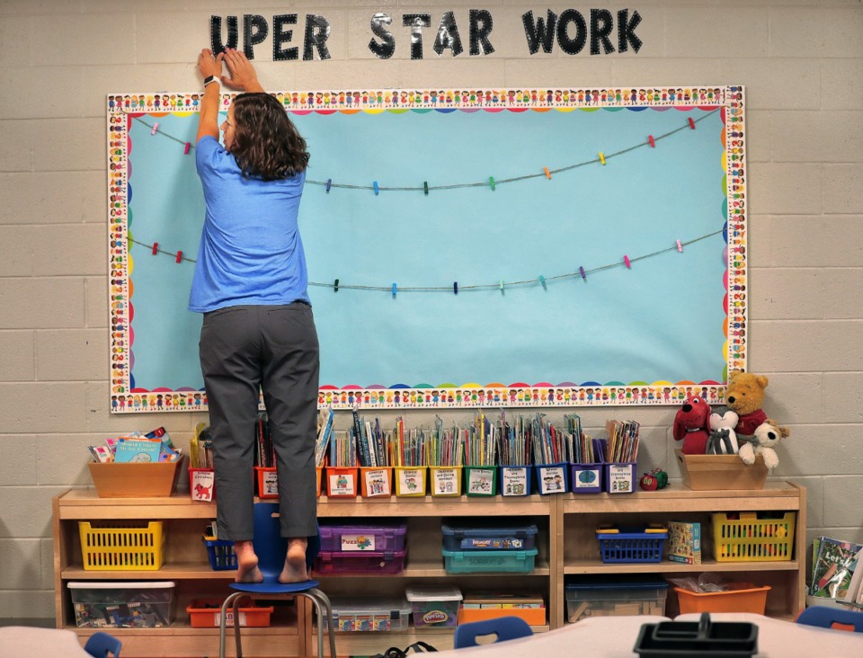 <strong>Kindergarten teacher Lori Matthews decorates her classroom as teachers, administrators and construction crews put the finishing touches on Germantown's new Forest Hill Elementary on Aug. 8, 2019.&nbsp;The school will welcome its first class of students next week.&nbsp;</strong>(Jim Weber/Daily Memphian)