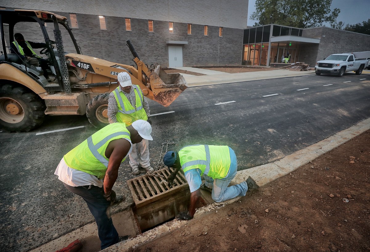 <strong>Workers replace a storm drain in front of&nbsp;Germantown's new Forest Hill Elementary as finishing touches are being put on the school on Aug. 8, 2019.</strong>&nbsp;(Jim Weber/Daily Memphian)
