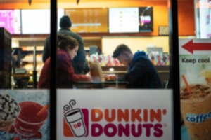<strong>In this Jan. 30, 2019, file photo customers sit inside a Dunkin' Donuts in New York. </strong>(Mark Lennihan/AP Photo File)