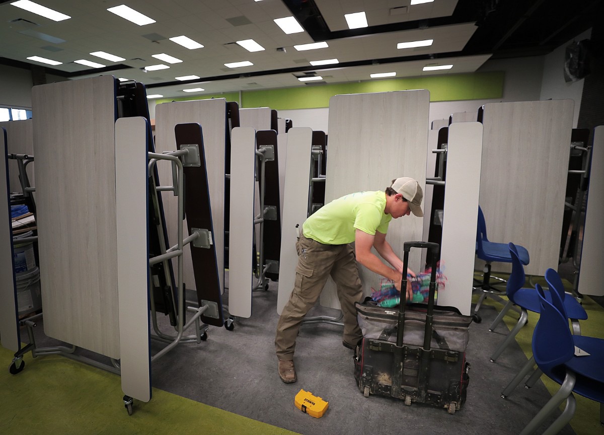 <strong>Brett Ashmore works on wiring in the cafeteria as teachers, administrators and construction crews put the finishing touches on Germantown's new Forest Hill Elementary on Aug. 8, 2019.</strong>&nbsp; (Jim Weber/Daily Memphian)