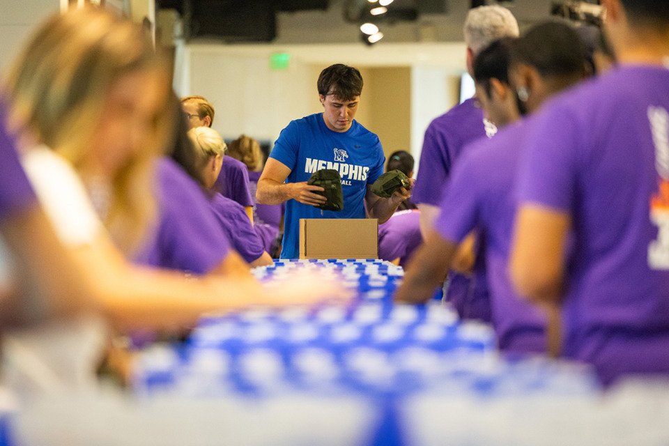 <strong>University of Memphis quarterback Seth Henigan helps FedEx interns fill toiletry-care packages July 16.</strong> (Benjamin Naylor/The Daily Memphian)