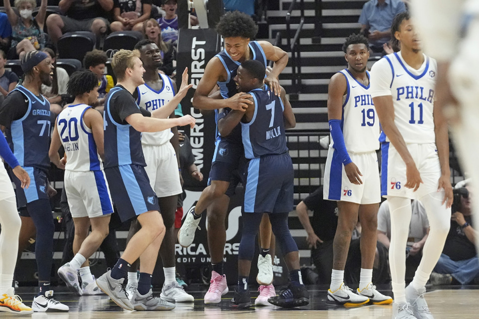 <strong>Memphis Grizzlies' Jaylen Wells, top center, is lifted into the air by teammate Isaiah Miller (7) after scoring the winning shot against the Philadelphia 76ers during the second half of an NBA summer league basketball game July 9 in Salt Lake City.</strong> (Rick Bowmer/AP file)