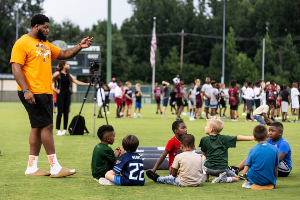 <strong>Omari Thomas (left), talks with kids while at the Briarcrest youth football camp led by former BCS stars Thomas, Jabari Small, Rodney Newsom and Reggie Neely.</strong>&nbsp;(Brad Vest/Special to The Daily Memphian)