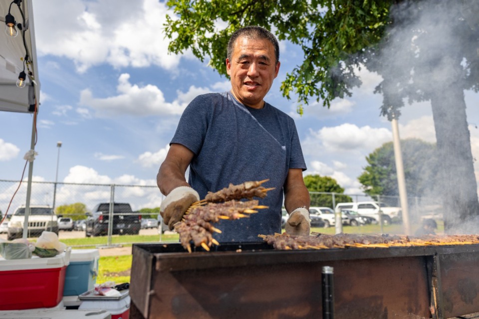 <strong>Vendors prepare food during Asian Night Market at Tiger Lane, Saturday, July 20.</strong> (Benjamin Naylor/The Daily Memphian)