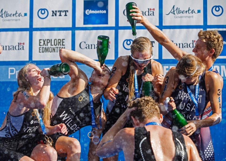 <strong>From left to right, Ainsley Thorpe, Hayden Wilde, Nicole Van Der Kaay and Mathew Hauser, of team New Zealand, celebrate as they are joined by the United States, Summer Rappaport and Seth Rider, after the elite mixed relay race at the ITU World Triathlon Series in Edmonton, Alberta, Sunday, July 21, 2019.</strong> (Jason Franson/The Canadian Press via AP, file photo)