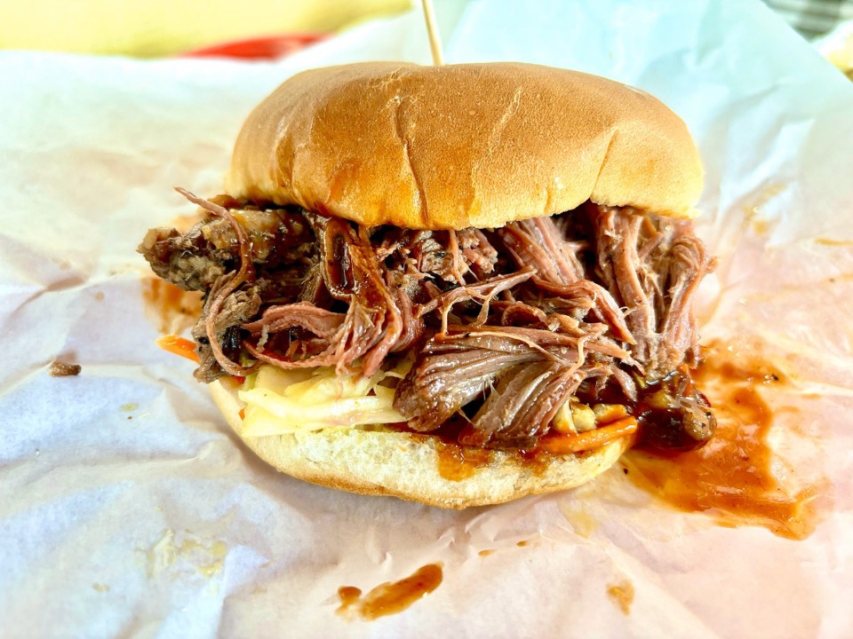 <strong>Tom&rsquo;s Barbecue brisket sandwich has a soft potato bun overflowing with soft, shiny shreds and slices of brisket. </strong>(Joshua Carlucci/Special to The Daily Memphian)