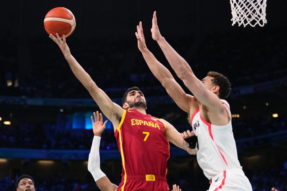 <strong>Santi Aldama, of Spain, shoots over Dwight Powell, of Canada, in a men's basketball game at the 2024 Summer Olympics, Friday, Aug. 2, 2024, in Villeneuve-d'Ascq, France.</strong> (AP Photo/Mark J. Terrill)