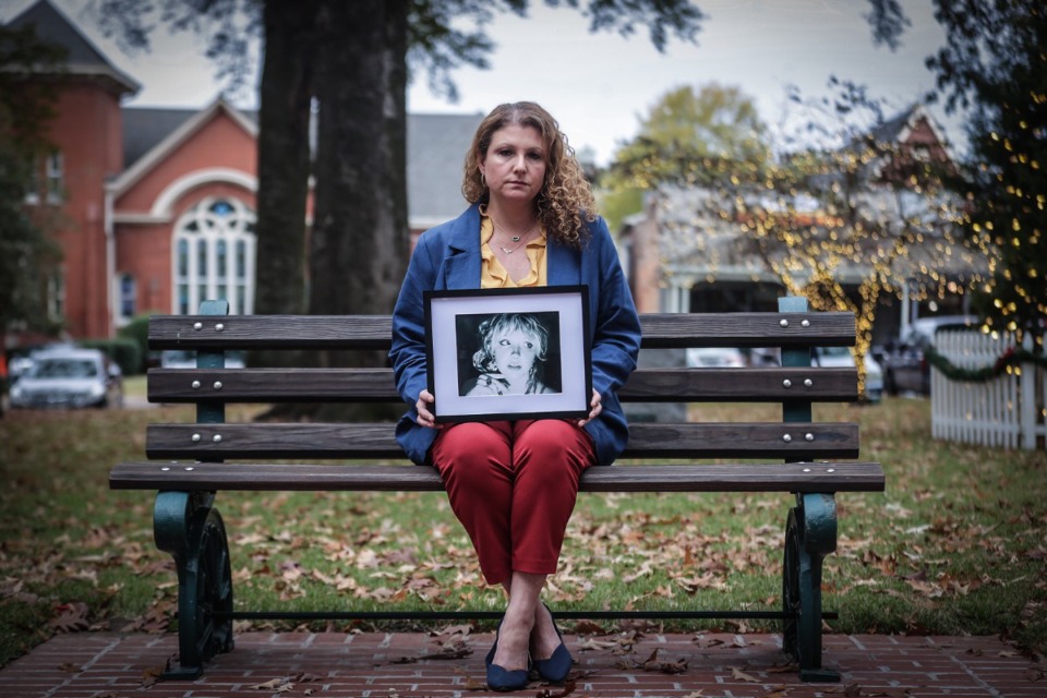 <strong>Angela Christopher poses for a portrait at Collierville Town Square on Nov. 16, 2023 with a photo of her 20-year-old daughter Ava, who was killed after her car was hit by someone driving a stolen car.</strong> (Patrick Lantrip/Daily Memphian file)