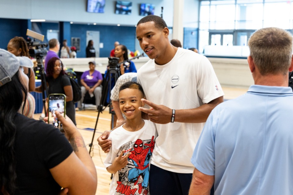 <strong>Loyale Blakemore, 10, left, gets a photo with Desmond Bane during MSCS&rsquo; Back to School supply giveaway at the Memphis Sports and Events Center.</strong> (Brad Vest/Special to The Daily Memphian)