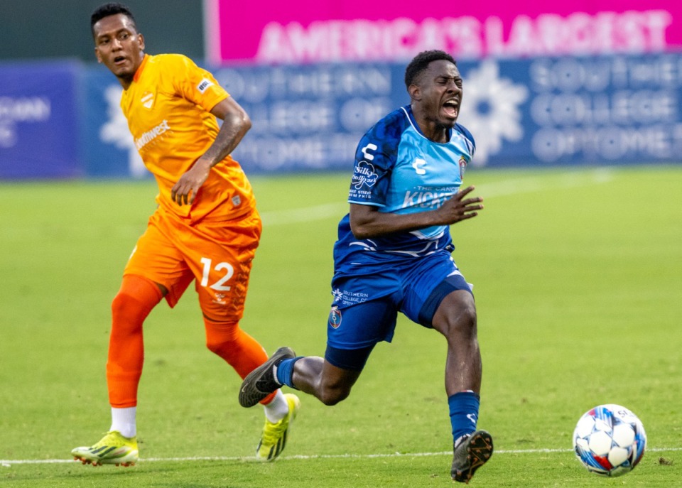 <strong>Akeem Ward (14) runs to keep the ball in bounds as El Paso's Wilmar Rivas (12) tries to defend at AutoZone Park, Saturday, Aug. 3, 2024. Memphis and El Paso played to a draw with both remaining scoreless.</strong> (Greg Campbell/Special to The Daily Memphian)