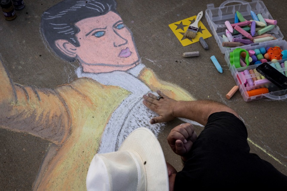 <strong>Greg Damron works on sidewalk art of Elvis along Elvis Presley Boulevard during the Elvis Week 2021 Candlelight Vigil Sunday, Aug. 15, 2021.</strong> (Brad Vest/Special to The Daily Memphian)