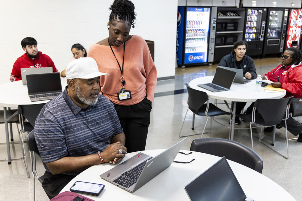 <strong>Nyrone Hawkins (left) gets help from Rokhaya Ceesay, with Tennessee College of Applied Technology, during the 901 FAFSA workshop hosted in April by Memphis Shelby County Schools and Tennessee College of Applied Technology.</strong> (Brad Vest/Special to The Daily Memphian)