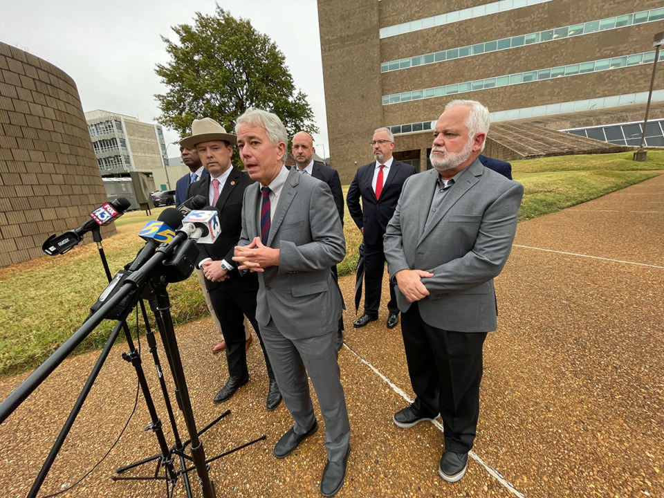 <strong>Shelby County District Attorney General Steve Mulroy (center) speaks Monday, Nov 7, 2022, outside the Shelby County Justice Center. He was joined members of the Shelby County District Attorney General&rsquo;s Office and 28th Judicial District Attorney General Frederick Agee (in hat) and Lance Huey (right), a former Arkansas sheriff and co-chairman of Responsible Growth Arkansas.</strong> (Julia Baker/The Daily Memphian file)