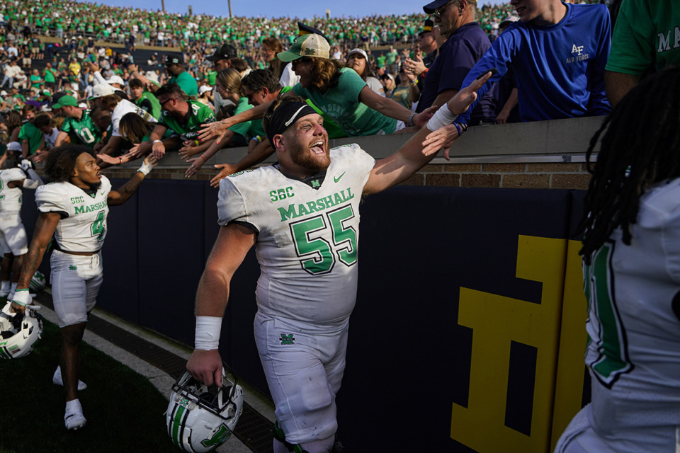 <strong>Trent Holler (55) celebrates with fans after Marshall's 26-21 win against Notre Dame in an NCAA college football game in South Bend, Ind., Sept. 10, 2022.</strong> (Michael Conroy/AP file)