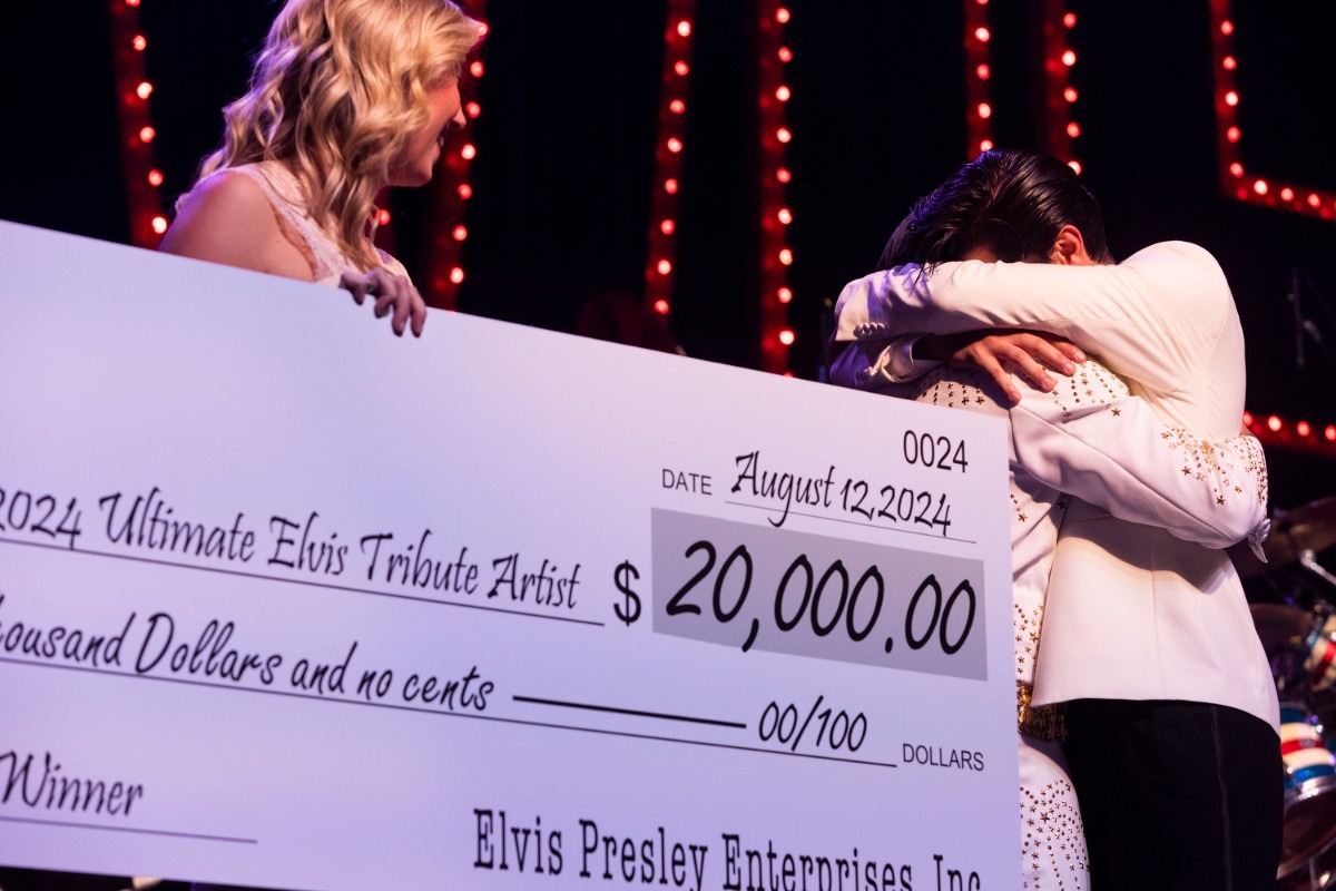 <strong>Emilio Santoro is given a giant check representing the $20,000 he won in the 2024 Ultimate Elvis Tribute Contest.</strong> (Brad Vest/Special to The Daily Memphian)