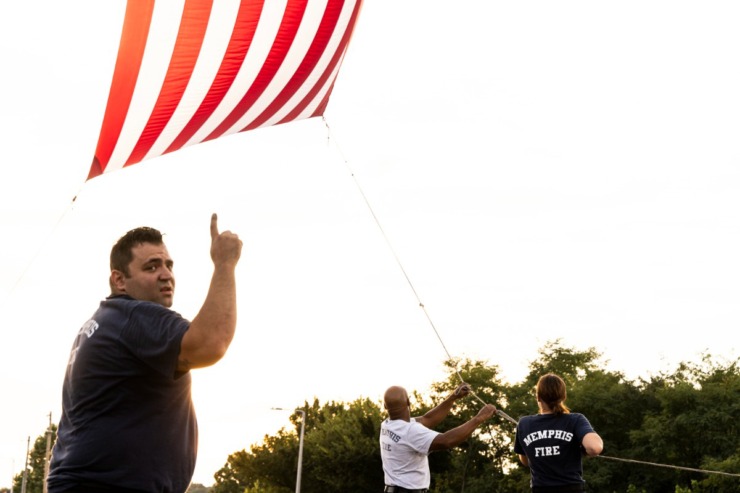 <strong>Members of the Memphis Fire Department raise a flag during the Memphis Police Department&rsquo;s Sea of Blue event on Aug. 14, 2024.</strong> (Brad Vest/Special to The Daily Memphian)