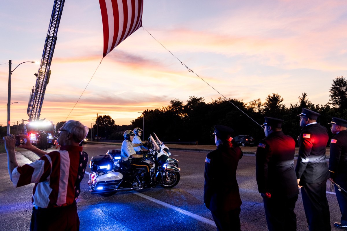 <strong>As the sun sinks into the Mississippi River Aug. 14, Memphis police officers show their respect for Demetrice Johnson.&nbsp;</strong>(Brad Vest/Special to The Daily Memphian)