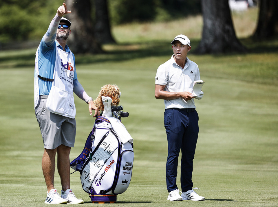 <strong>PGA golfer Collin Morikawa, right, and caddie Jonathan Jakovac test the wind at No. 10 during the FedEx St. Jude Championship on Thursday, Aug. 15.</strong> (Mark Weber/The Daily Memphian)